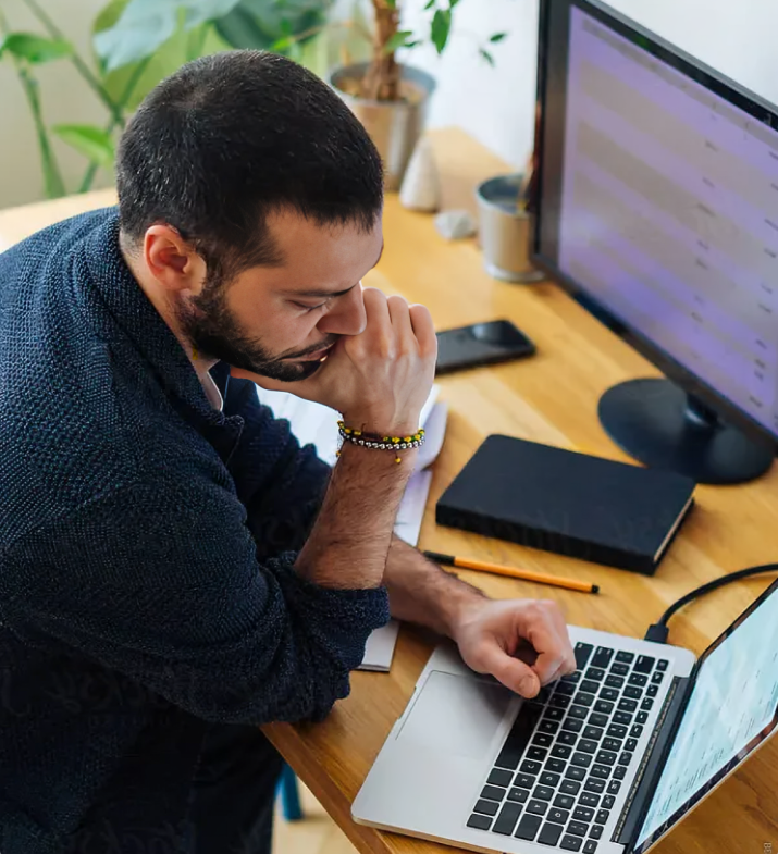A professional reviewing their CV on a laptop